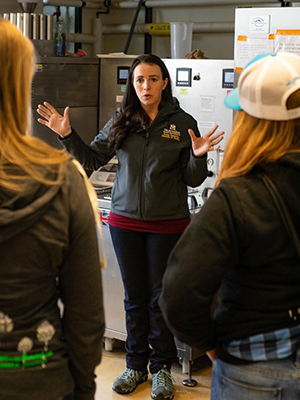 Hannah Turner leads attendees of the Pink Boots Winter Weekend even in a tour of the Malt Quality Lab