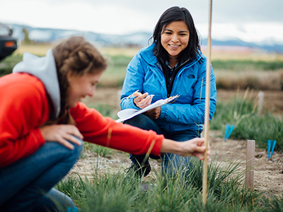 Two students conduct a field study.
