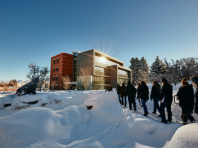 A tour crosses campus in winter.