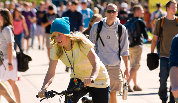 A student rides ehr bike on campus