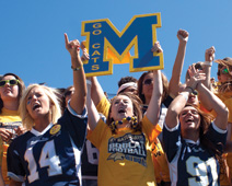 Fans cheer on the Bobcats while wearing blue and gold