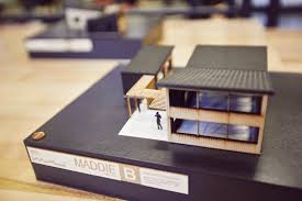 miniture building model sitting on top of a black binder