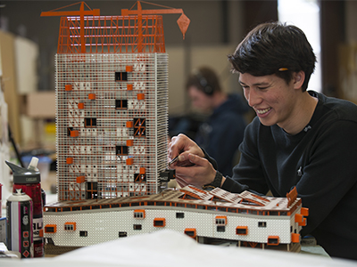 Student tinkering with architecture model