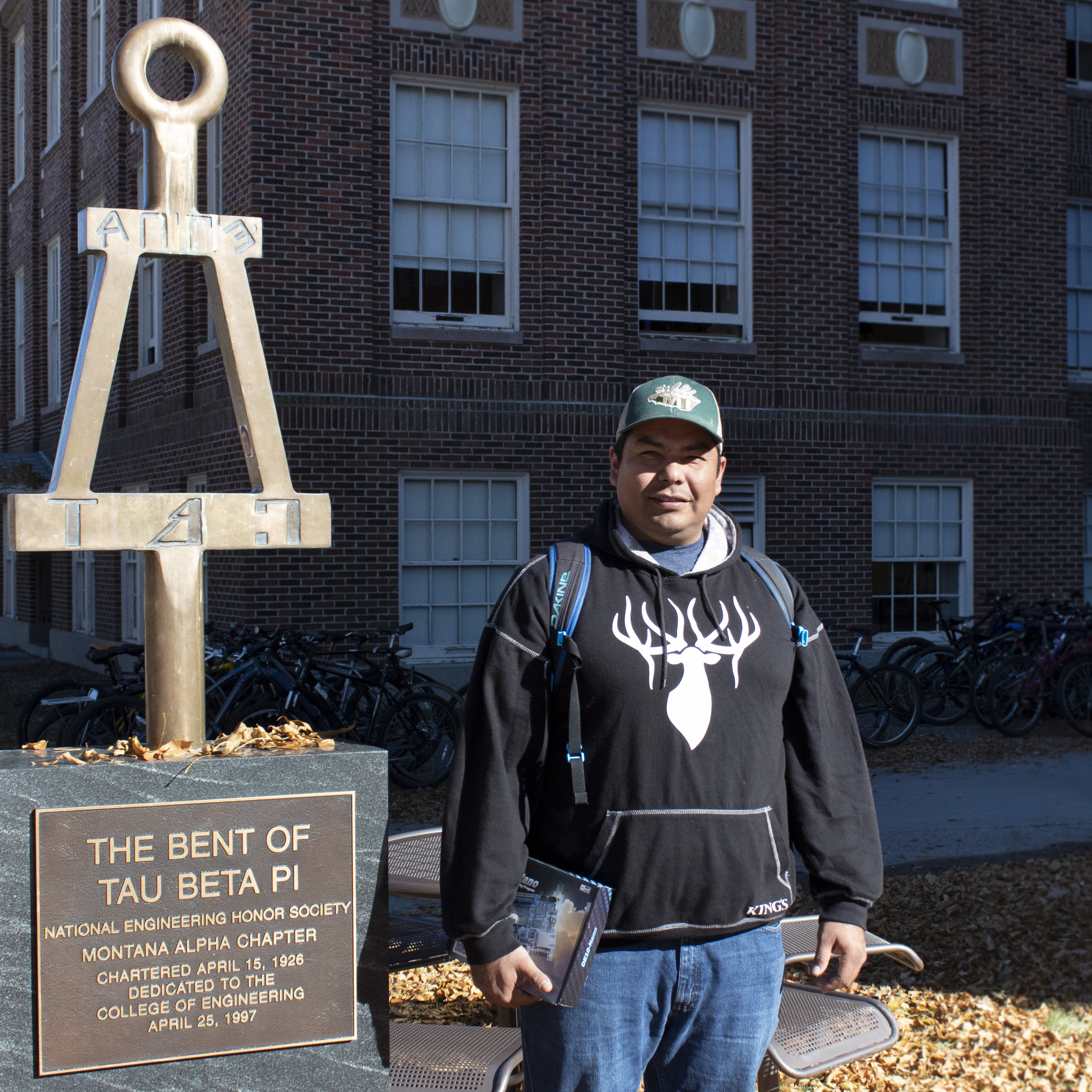 A picture of Randall beside the bent of tau beta phi