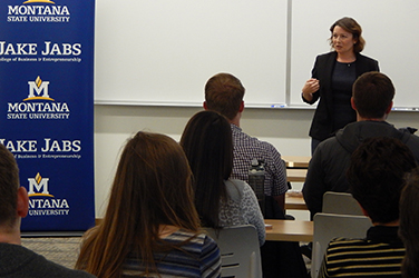 An alum speaks to students in a classroom.