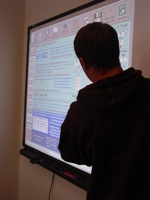 Student in front of a smart board