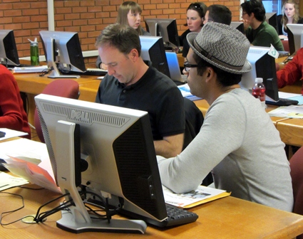 An accounting student helps an individual utilizing the free tax preparation services provided by the Jake Jabs College of Business & Entrepreneurship
