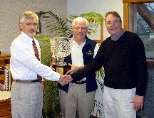 Steve Wheeler receives crystal trophy from Norm Millikin and Dean Rich Semenik