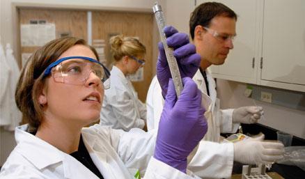 students and faculty work in a laboratory
