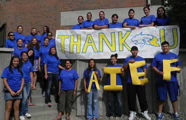 Students holding Thank You AIEF banner