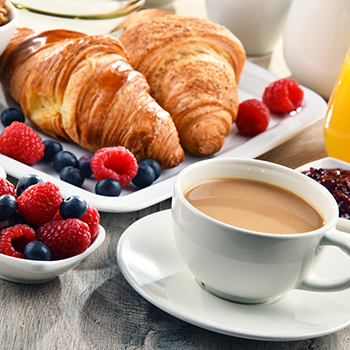 croissants, mixed berries, and a cup of coffee