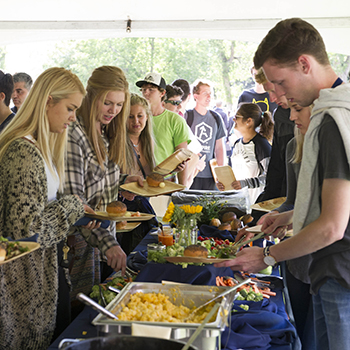 students plating food at a catered buffet event