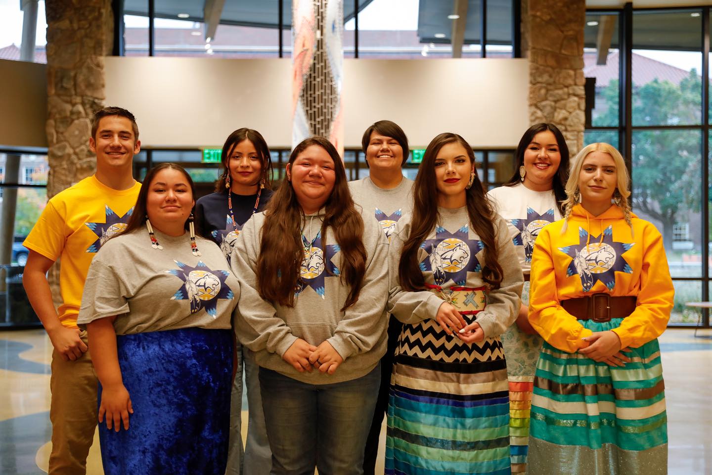 8 American Indian individuals smiling at the camera
