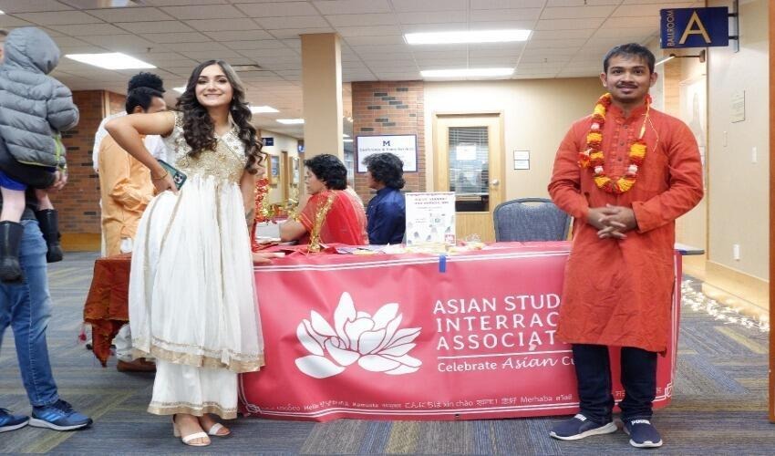 two students in traditional asian clothing at a mutlicultural night