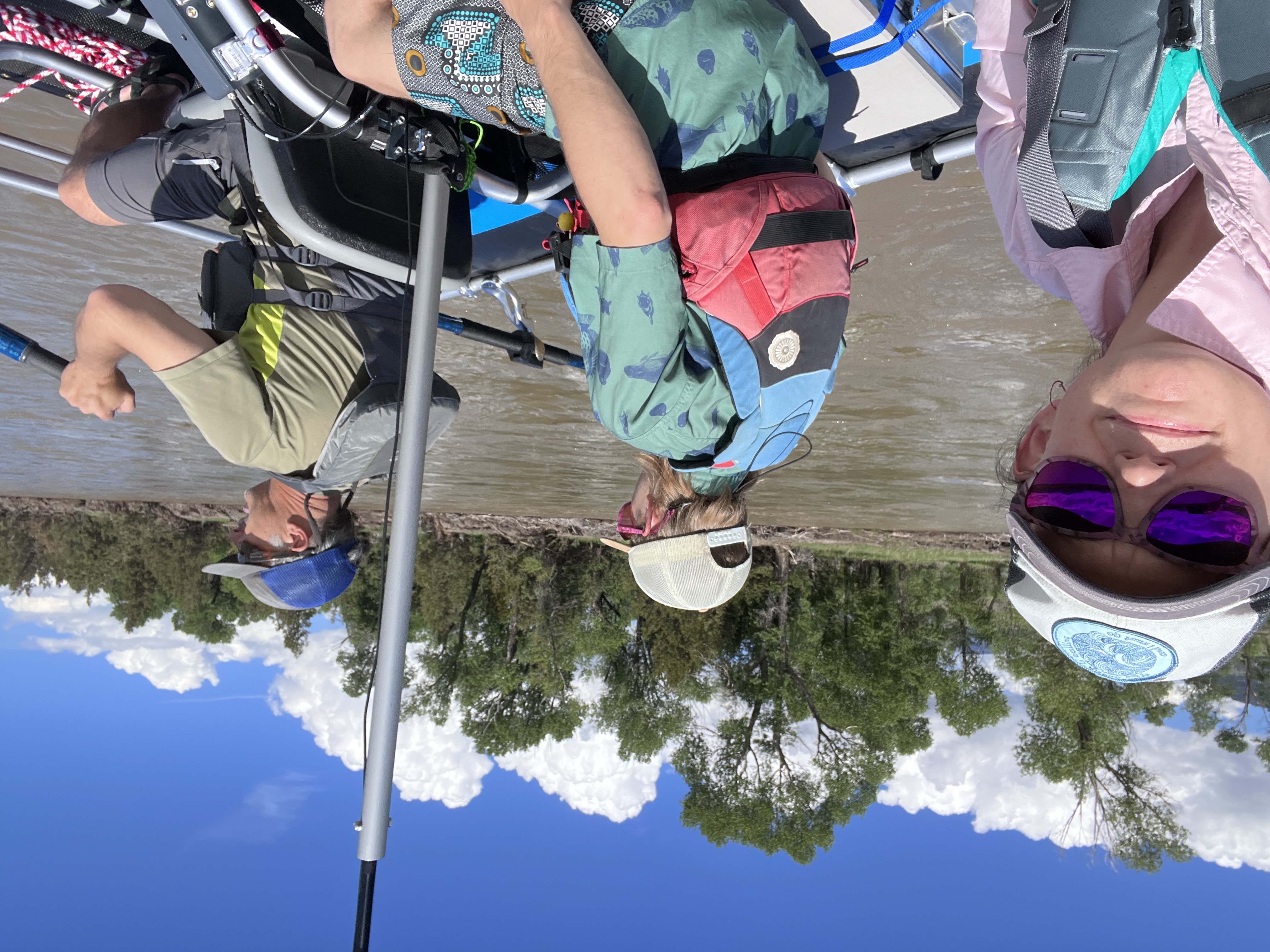 Photo of Katey, Eric, and TJ in a cataraft on the Yellowstone River