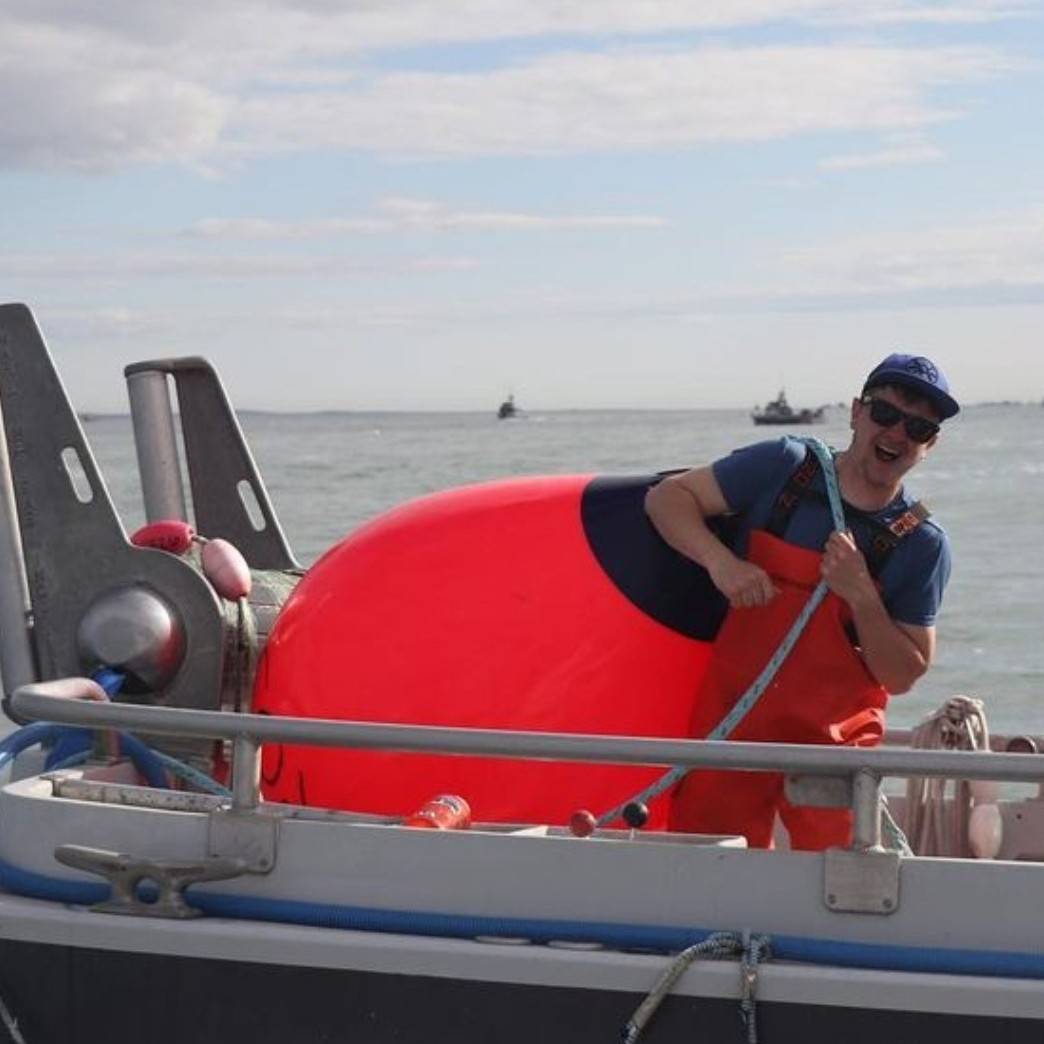 Photo of Tor Sather holding a Buoy