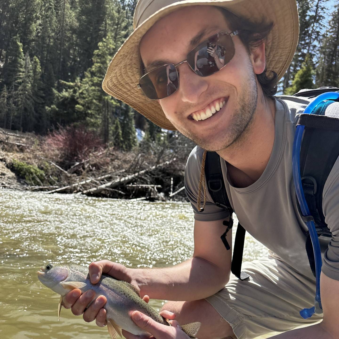 Photo of Sam Curtis holding a fish
