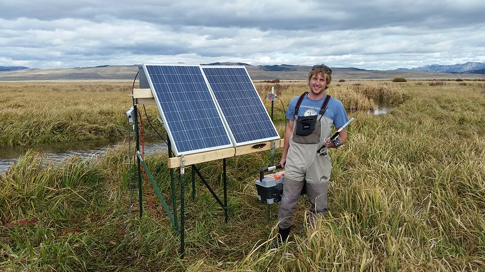 Jason Marsh with solar panels in the field