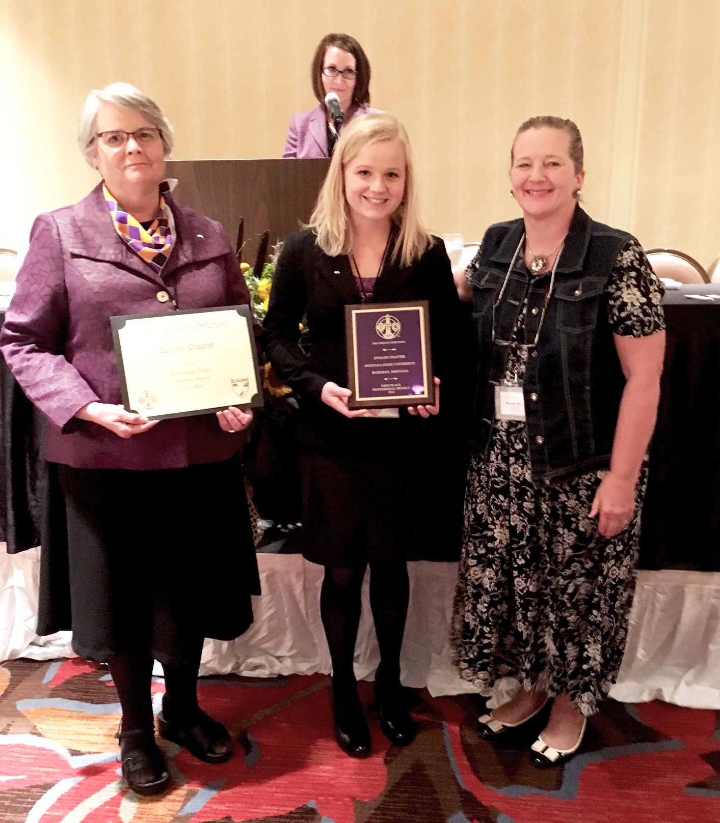Dr. Sandy Osborne and Sierra Smith accept award on behalf of Phi Upsilon Omicron for professional project at national competition