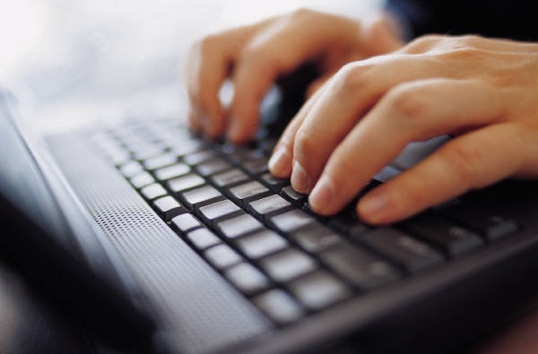 Student typing on a keyboard