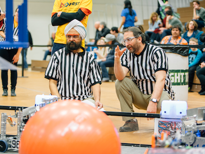 two men judging FIRST Tech Challenge event