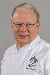 photo of Mark Floerke wearing a chef's jacket