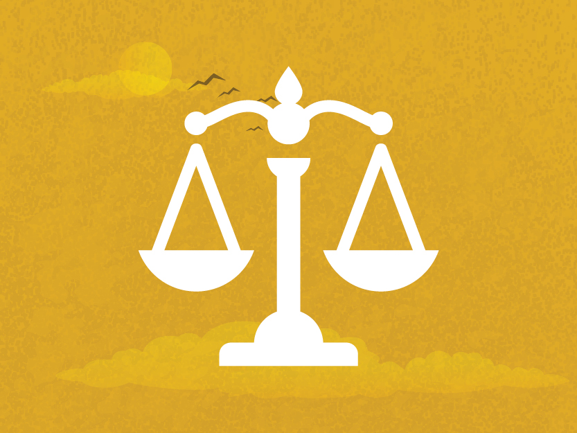 Image of justice scales on a golden sky background.
