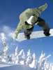 Snowboarder in air grabbing the tail of the snowboard