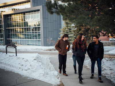 Four international students walking in front of Jabs Hall.