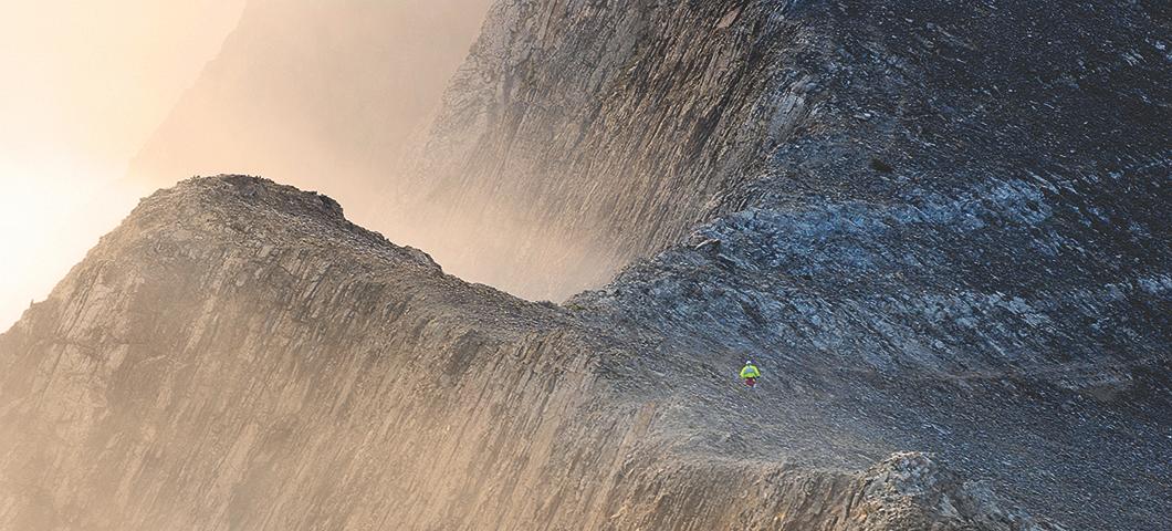 Runner jogging across a mountain ridge