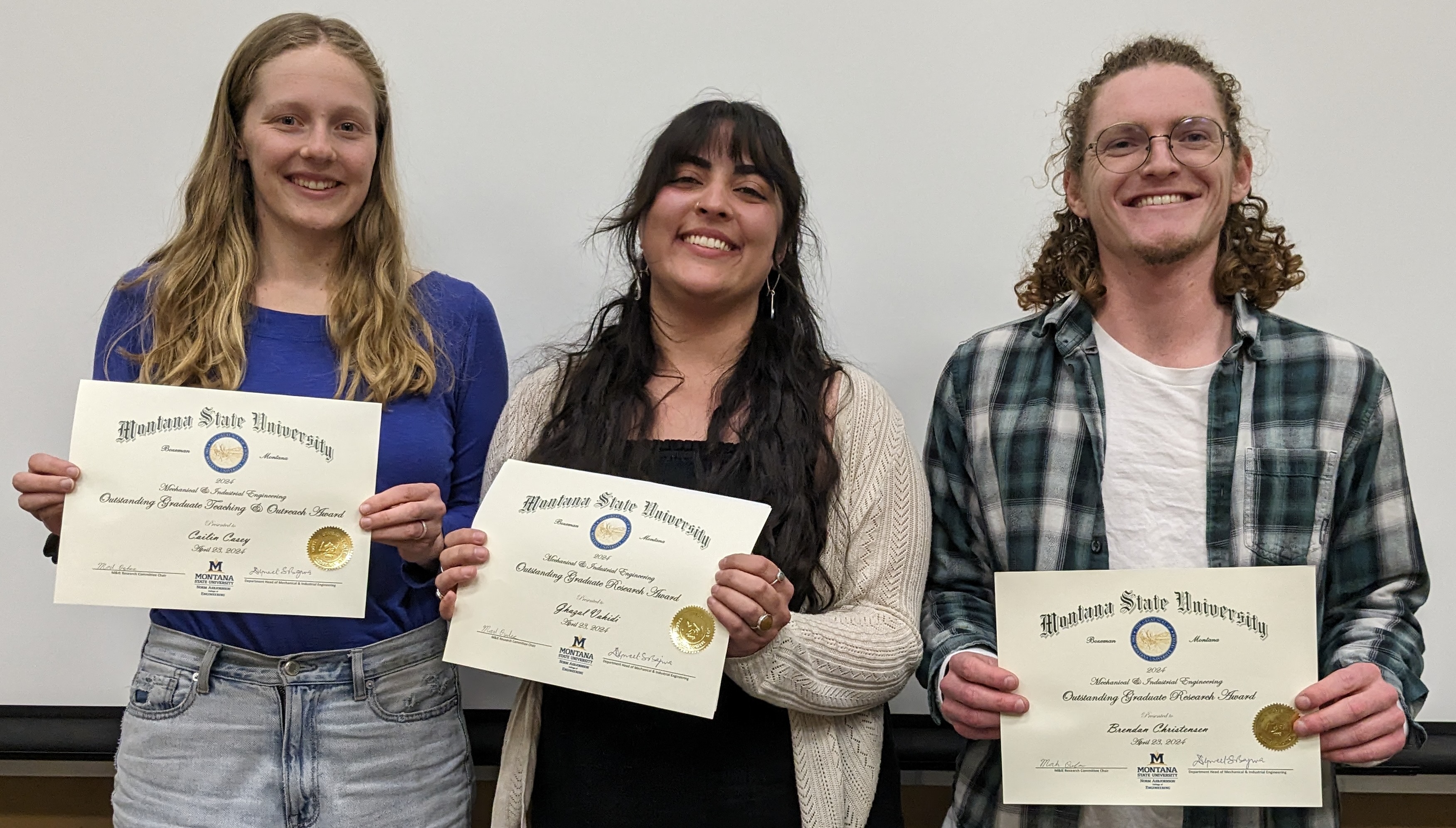 Three graduate students receiving award