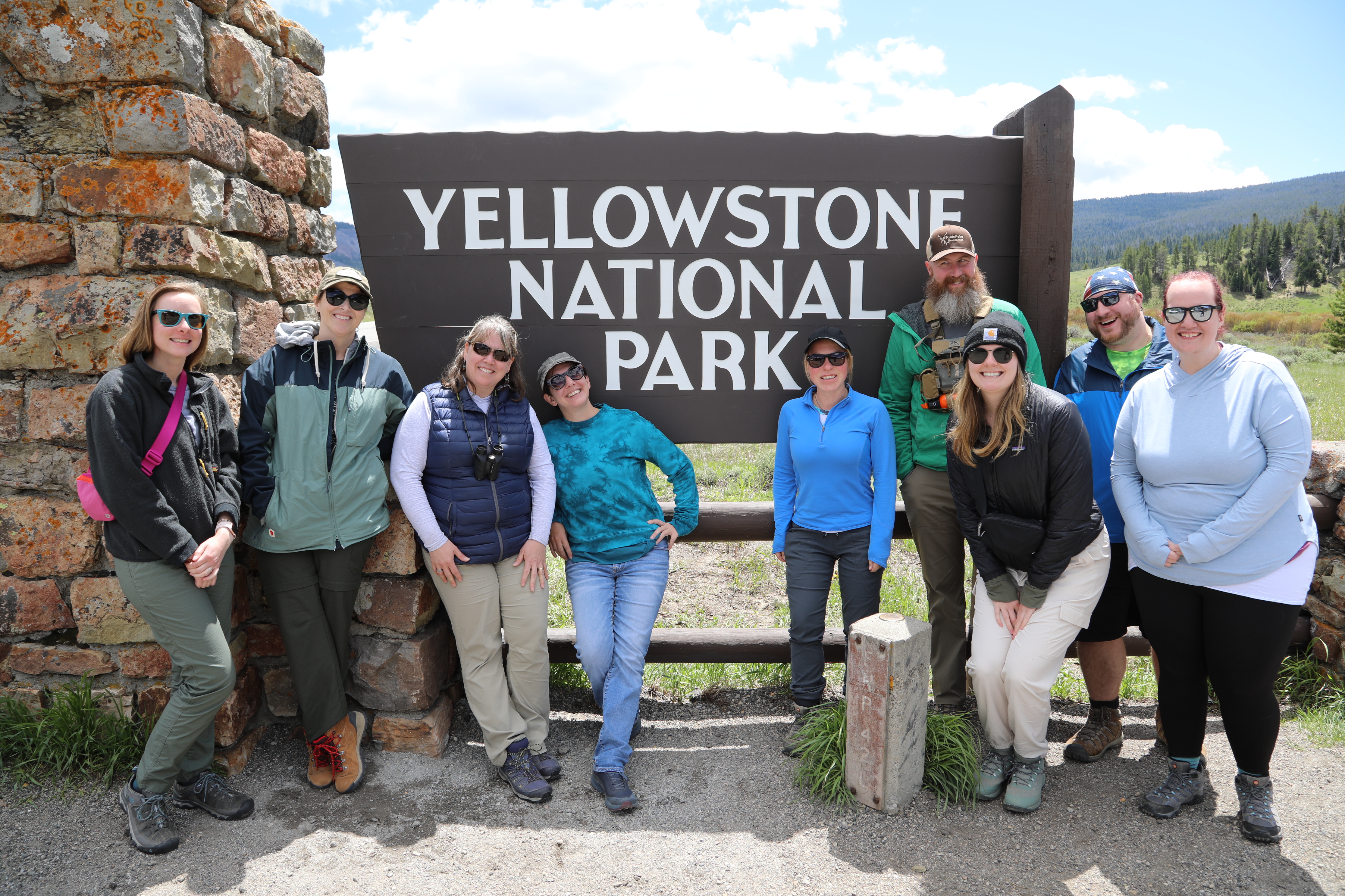 Students posing in front of Yellowstone National Park sign