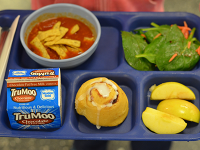 Harvest of the Month lunch tray - chili, cinnamon roll, salad, and milk Harvest of the Month lunch tray - chili, cinnamon roll, salad, and milk