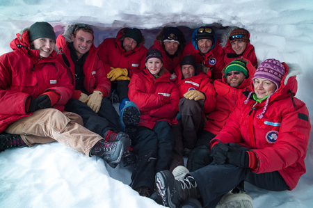 team in red under ice cave