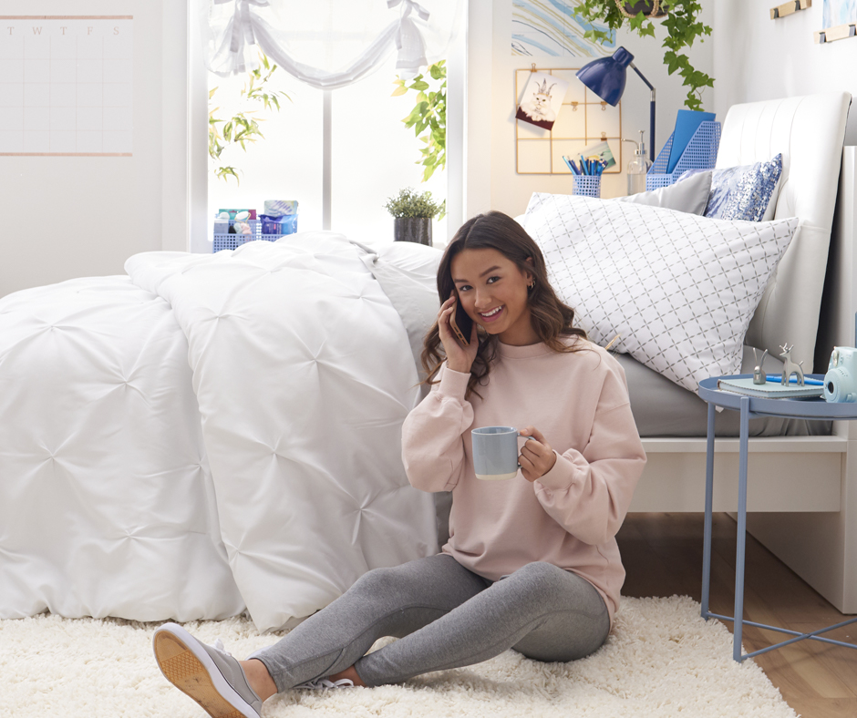 Girl on phone against bed