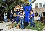 Three members of the rodeo team posing with the MSU Bobcat mascot