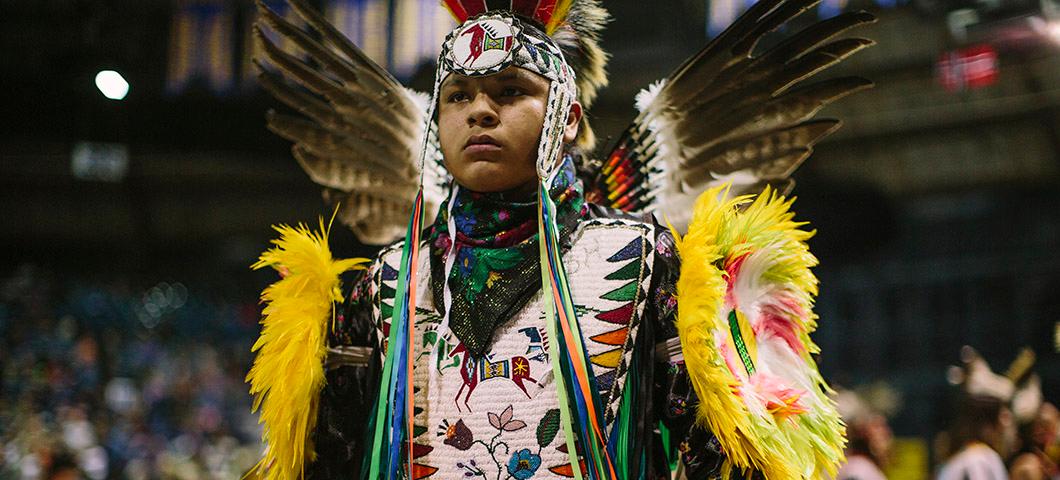 A Native American man in traditional dance regalia