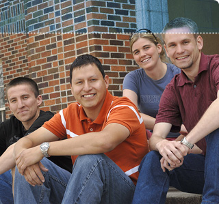 Students sit on building steps