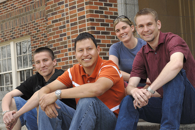 Students sit on building steps