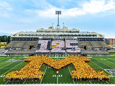 Photo of students forming the M on the MSU football field