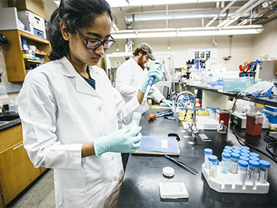 Female student conducting chemical engineering research in a lab