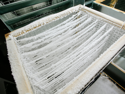 close-up photo pf strings holding snow crystals in a snow-making device