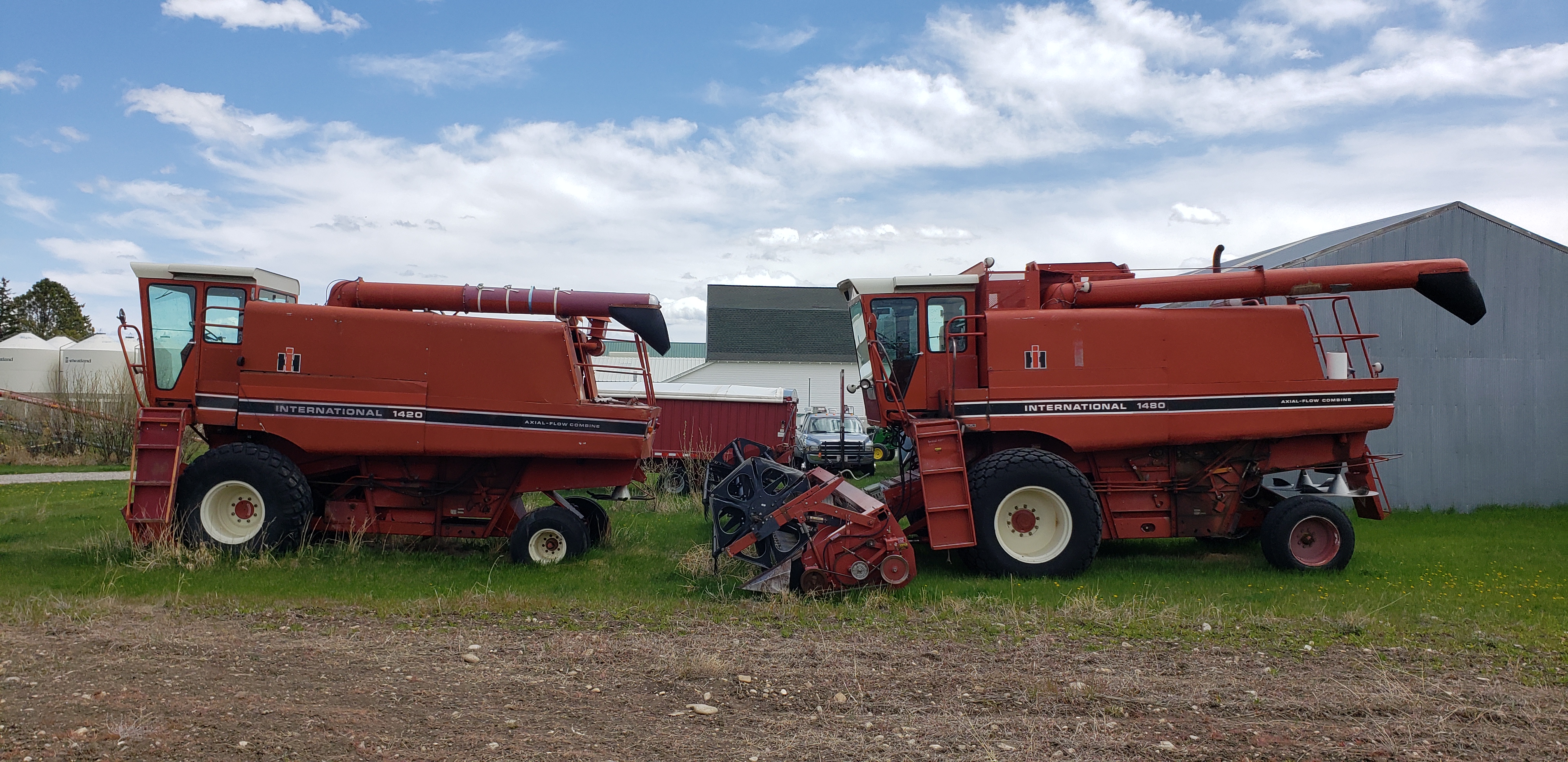 Two Red combine farm vehicles