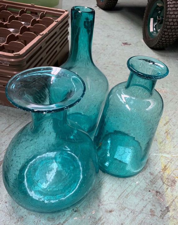 Three blue glass decorative bottle vases