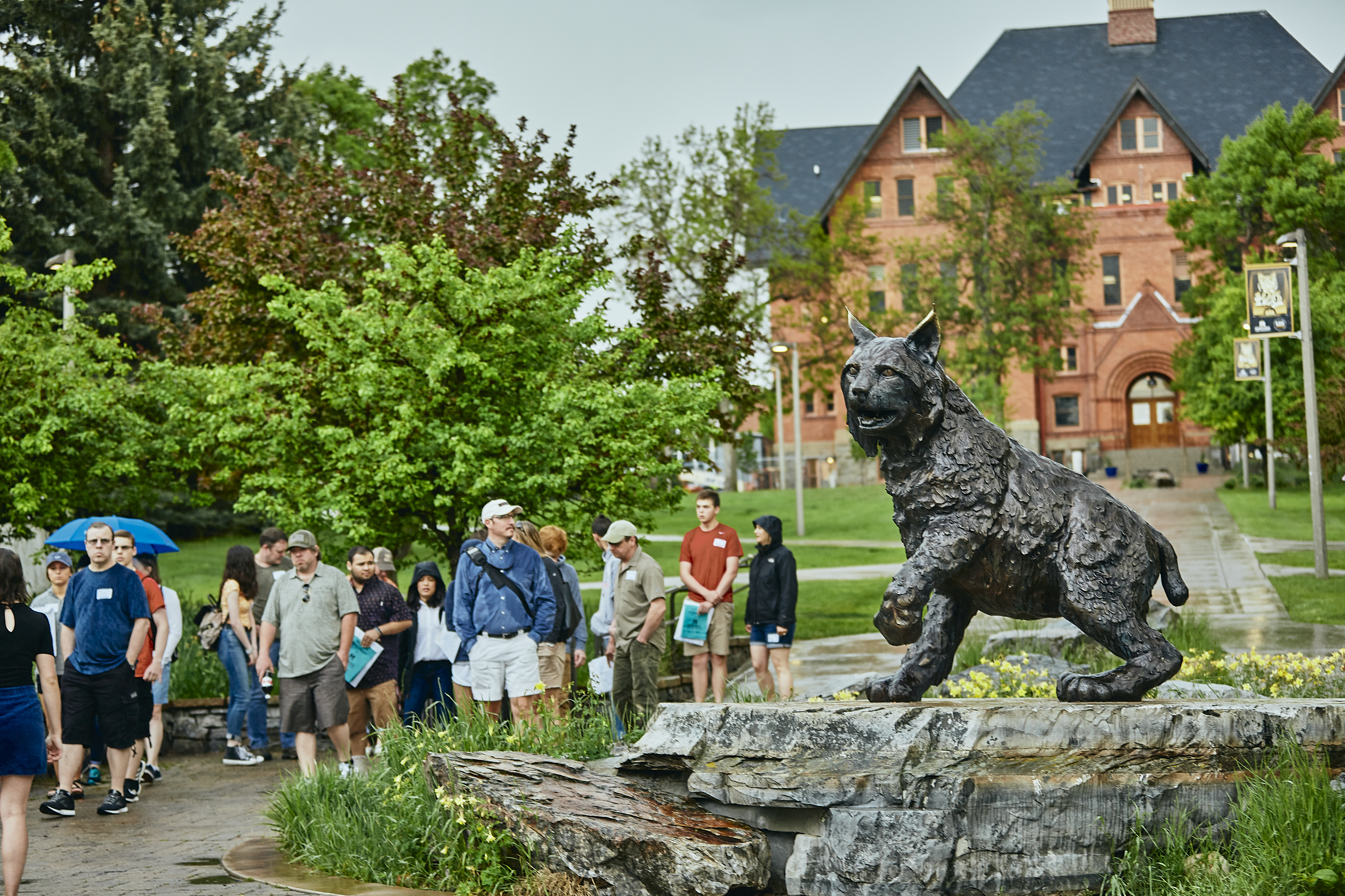 Prospective students on a tour near the Champ statue