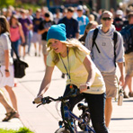 A student rides ehr bike on campus