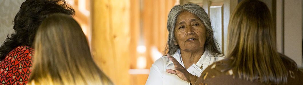 A Native American elder talks to a group of students.