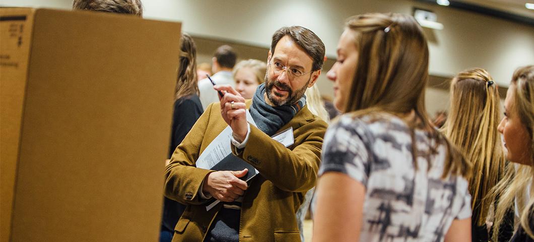 A faculty member discusses a student's research project.