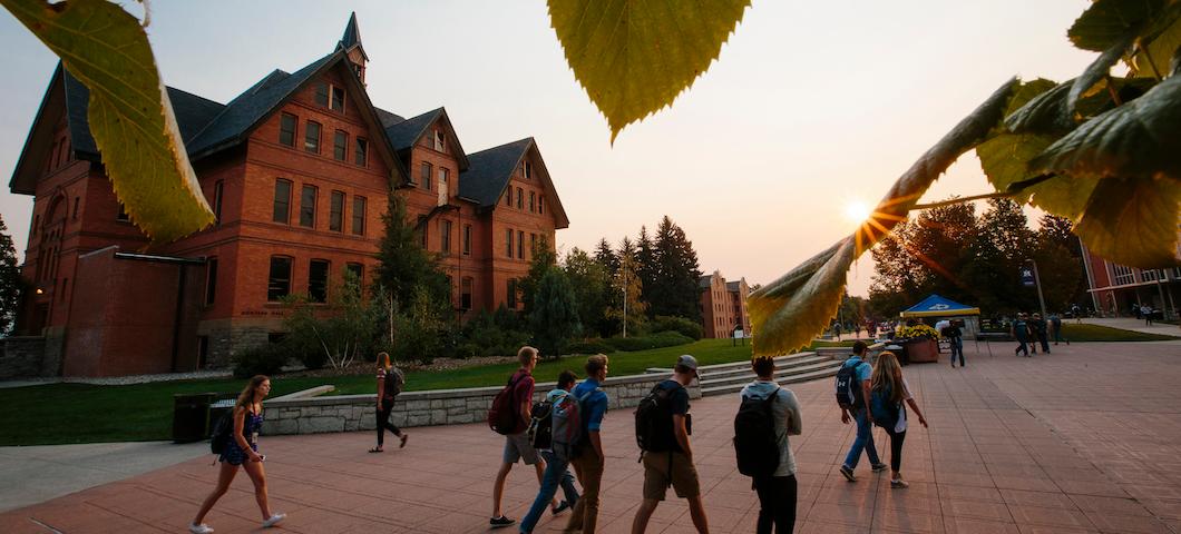 Students walk by Montana Hall on Centennial Mall early in the morning