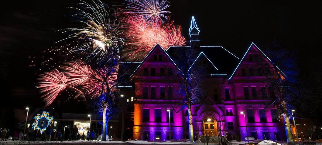 Fireworks over Montana Hall in the winter.